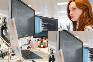 A woman in an office researching customer relationship management on her computer