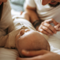 parents_holding_their_newborn_baby_at_home