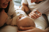 parents_holding_their_newborn_baby_at_home