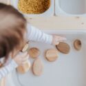 Photo by Tatiana Syrikova: https://www.pexels.com/photo/crop-anonymous-child-getting-brown-stones-from-white-container-at-home-3933101/