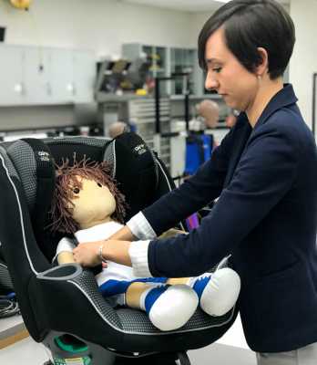 Julie Mansfield straps a doll into a car seat. Rear-facing car seats are known to protect children in front and side impact crashes, but are rarely discussed in terms of rear-impact collisions. In a new study, researchers at The Ohio State University Wexner Medical Center explored the effectiveness of rear-facing car seats in rear-impact accidents by conducting crash tests with different car seat types and features.