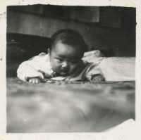 “Chinese baby laying on a bed” by simpleinsomnia is licensed under CC BY 2.0